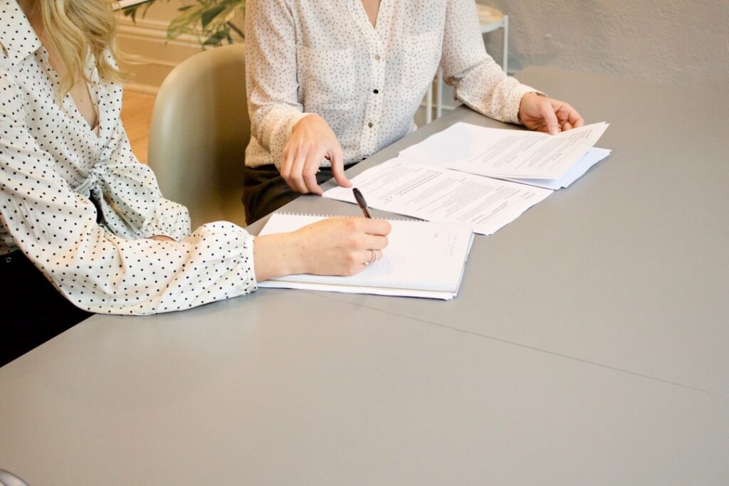 Borrower signing loan paperwork with a credit union loan officer after bankruptcy