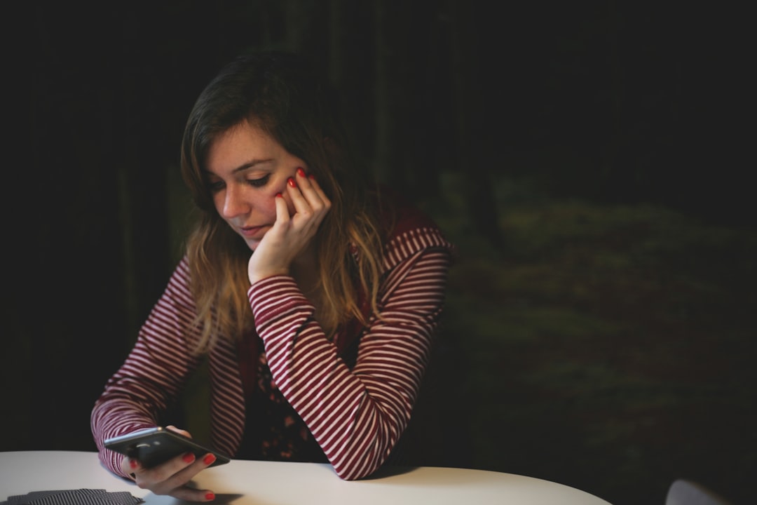 Person setting down their phone in relief after creditor calls stop following a bankruptcy filing