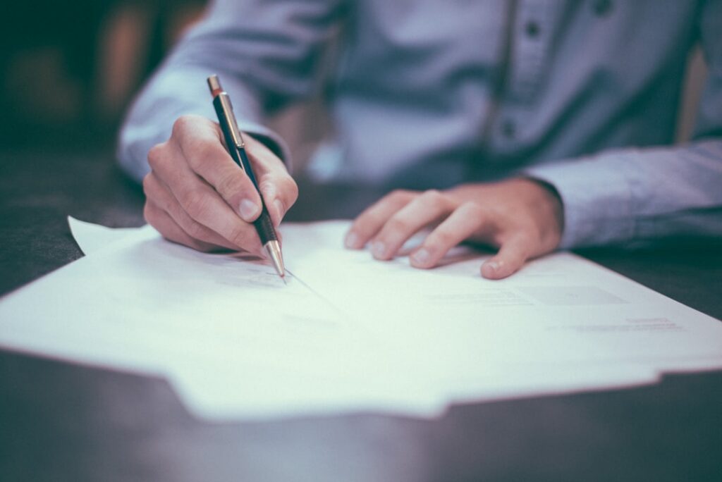 Co-signer reviewing and signing a loan agreement